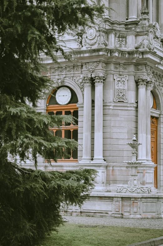 an ornate building has a big clock on it's side