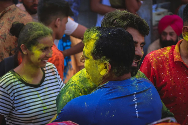 people celeting with colors all over their bodies