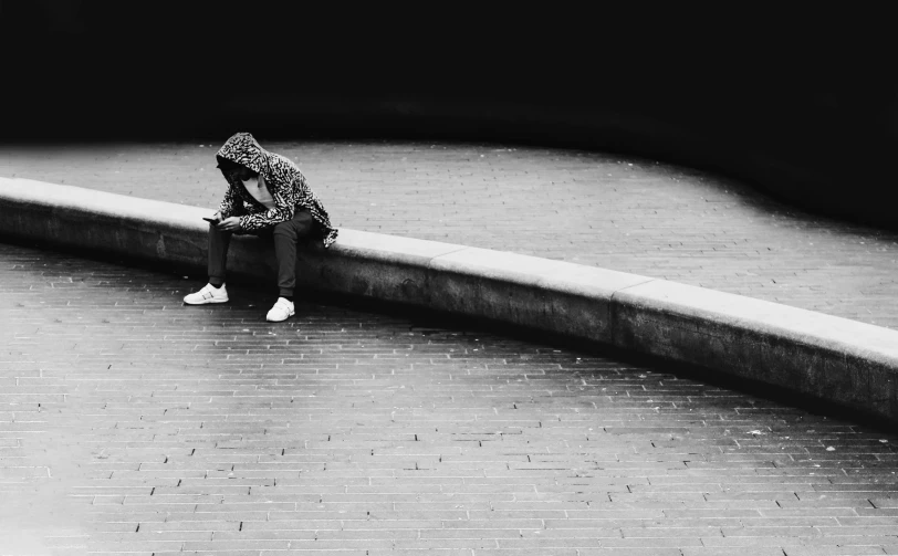 a black and white po of a girl sitting on a bench