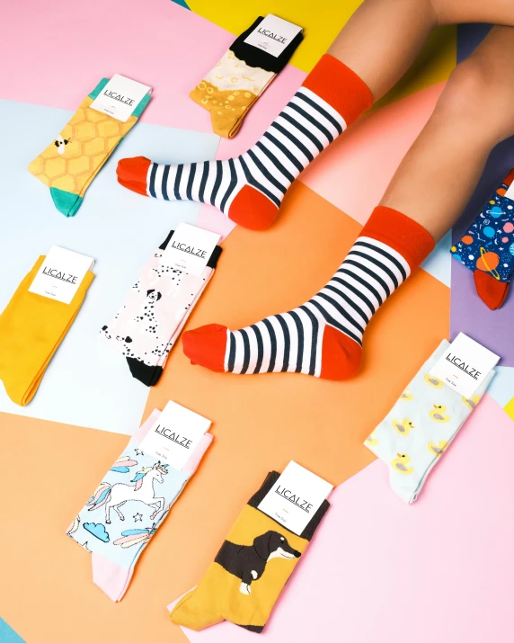 a pair of people with colorful socks on top of a table