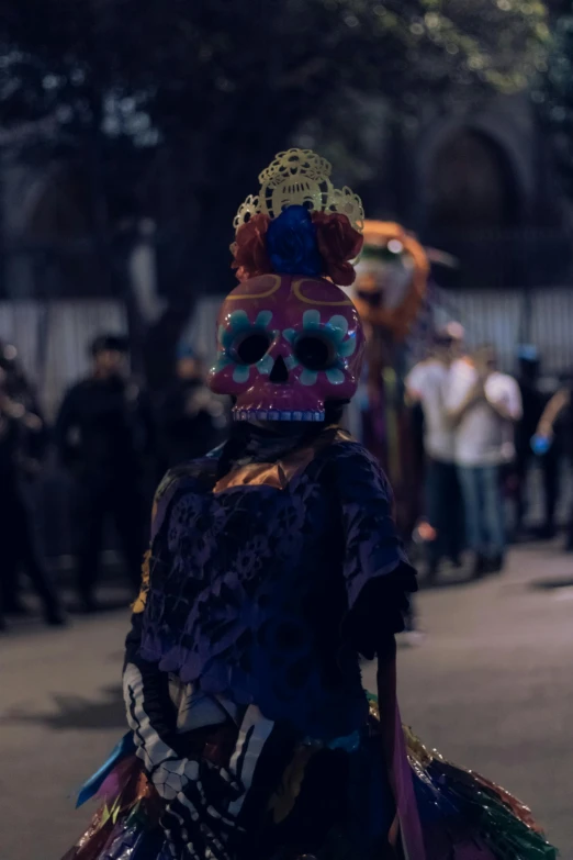 a woman with a weird mask on, walking down the street