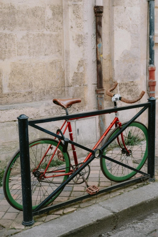 a bicycle is parked on the sidewalk near the street