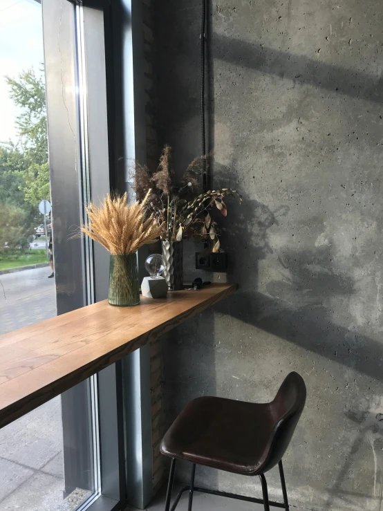 a chair in front of a window with flowers and some items