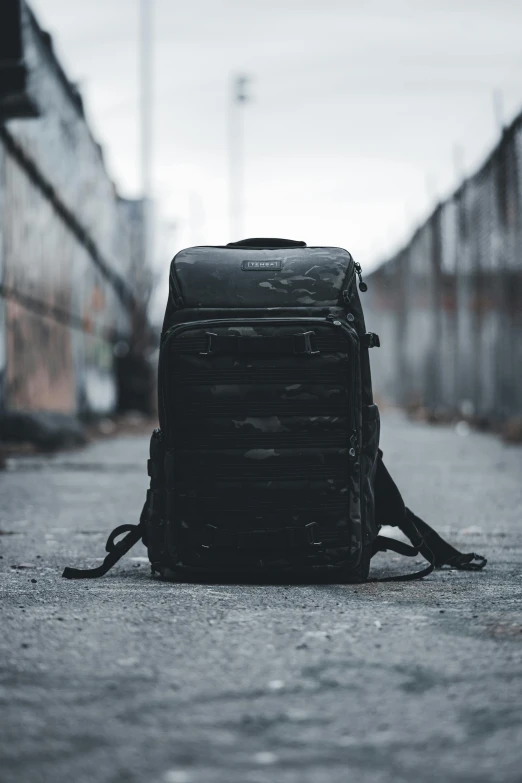 a large backpack sitting on the ground by a building