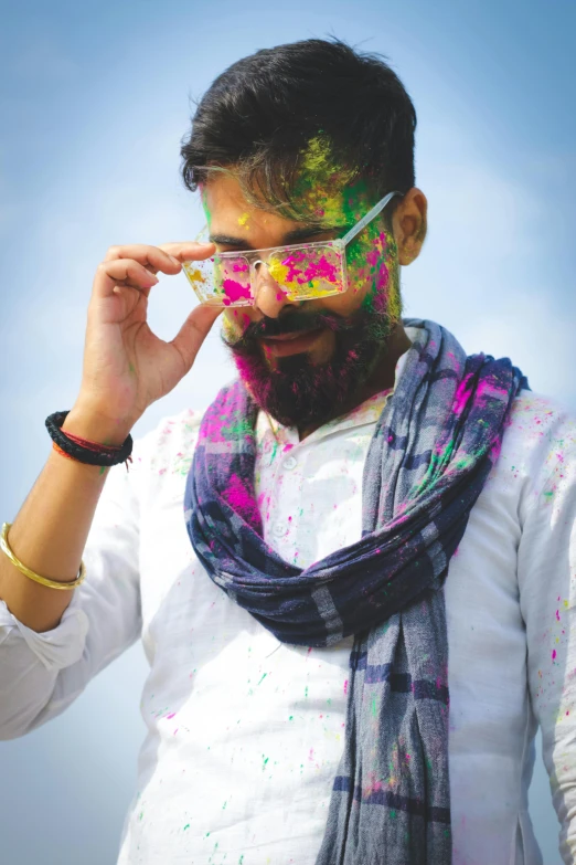 man in white shirt with holi mask looking at camera