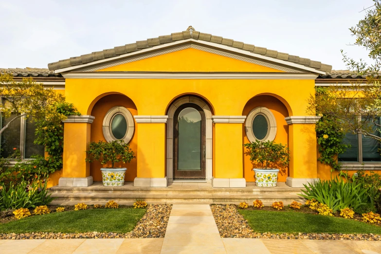 a house with some windows and flowers in pots