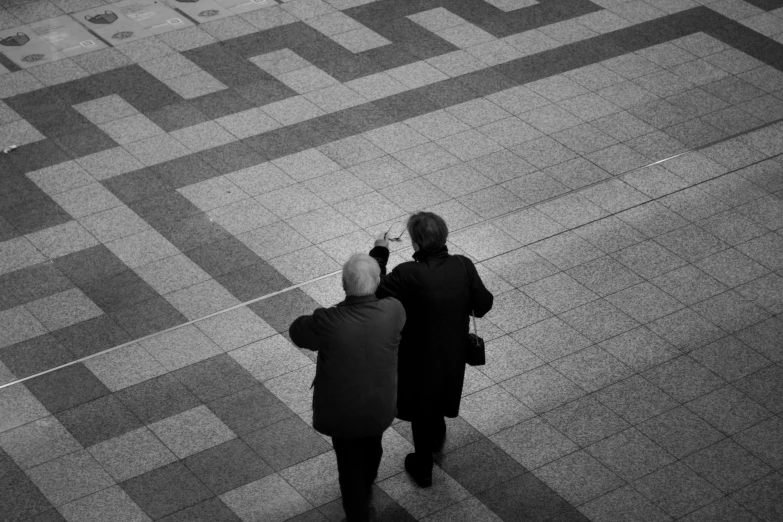 two people on a street with a phone