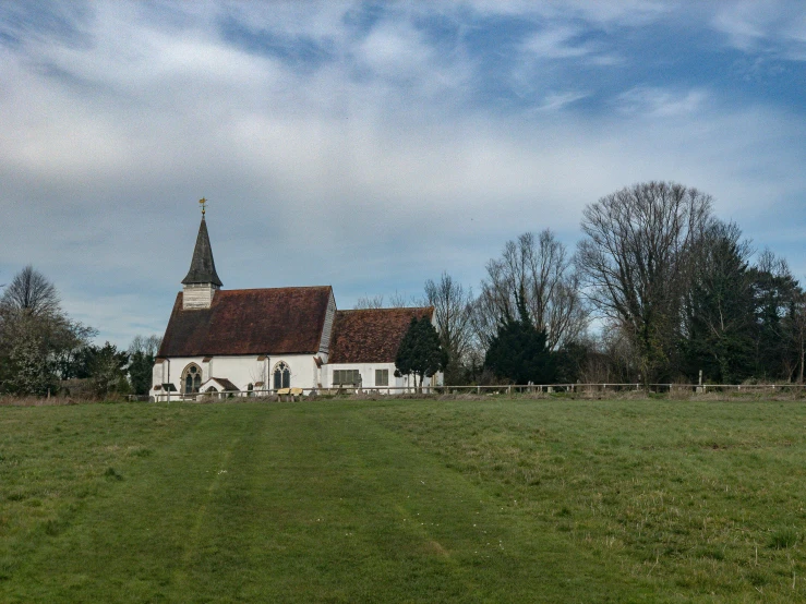 a building in the middle of a green grass field