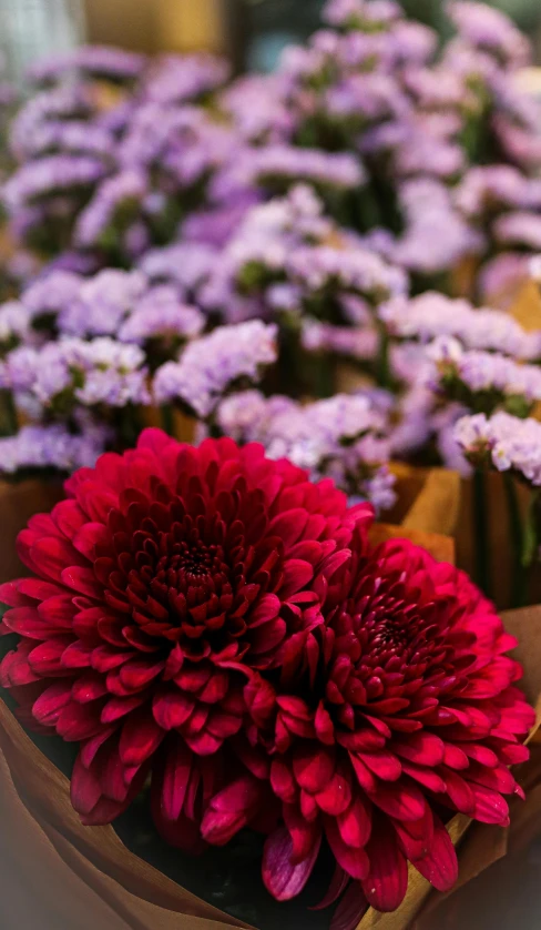 a table topped with lots of flowers next to a wooden cake