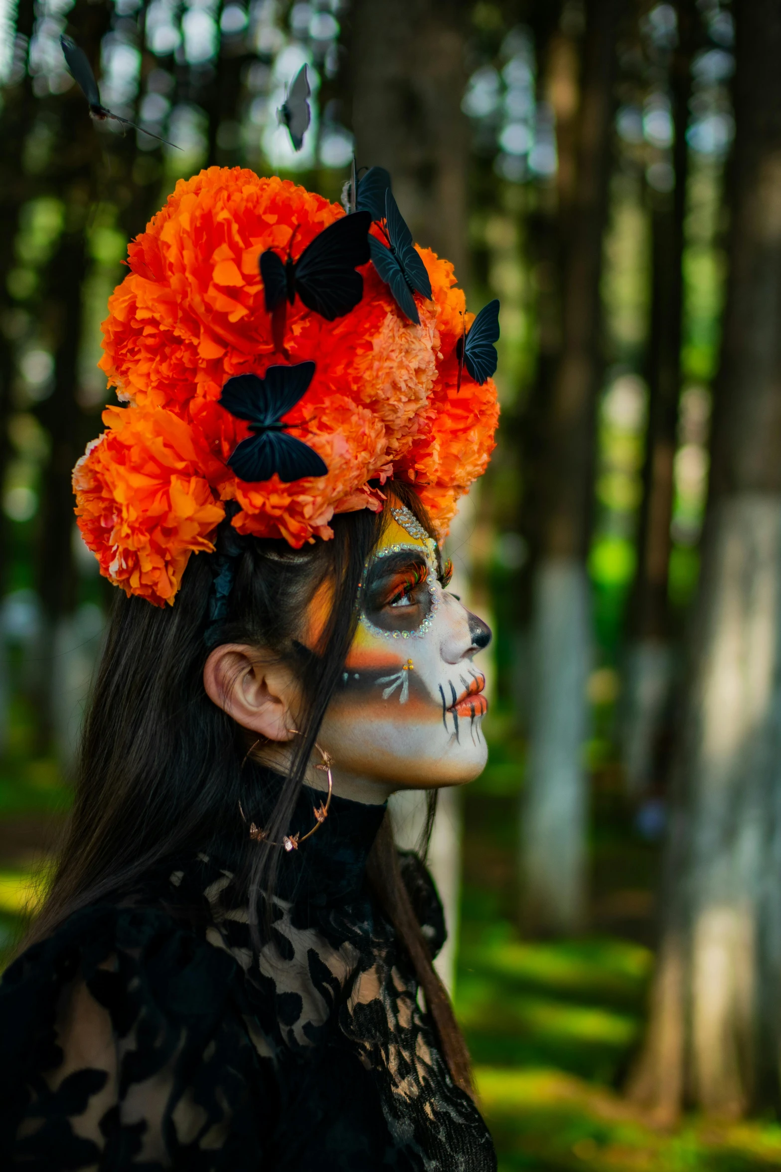 a woman is wearing a orange flower wreath and erflies