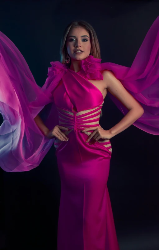 a beautiful woman in a pink gown with long cape