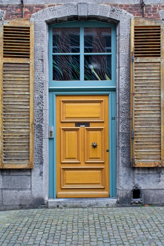 a bright yellow door and window in an old building