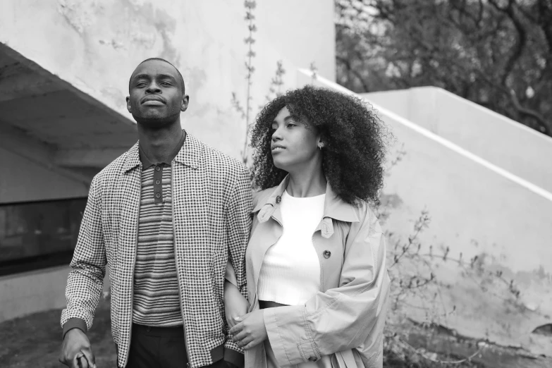 black man standing next to his wife on a street