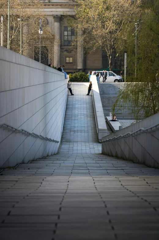 the people walk over concrete steps next to the sidewalk