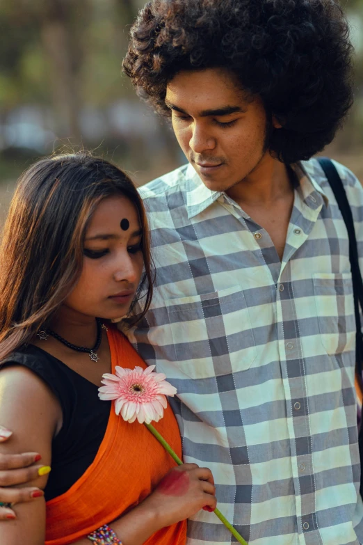 a boy standing next to his girlfriend in front of him