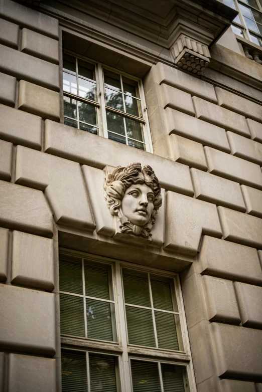 a tall building with a window and a head of a man