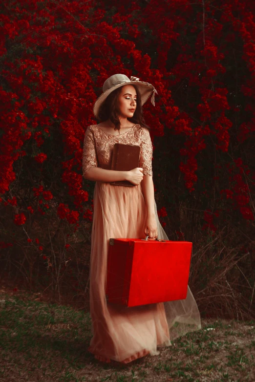 a woman in an dress and hat holding a suitcase