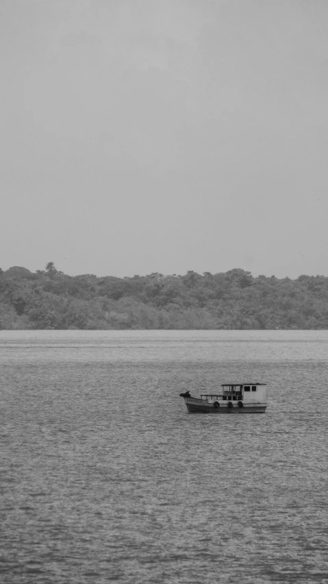 a small boat in the middle of a lake