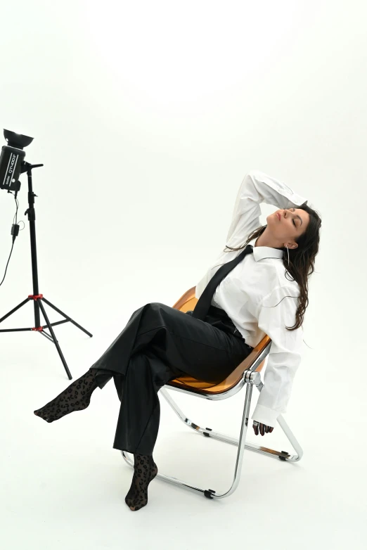 woman sitting in chair in front of a pography studio