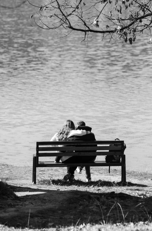 a man sitting on a bench next to a woman