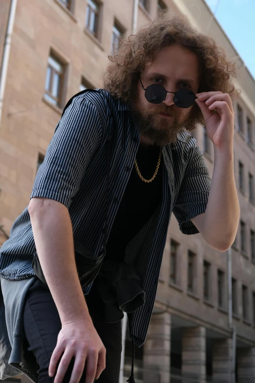 a bearded man is riding on his skateboard