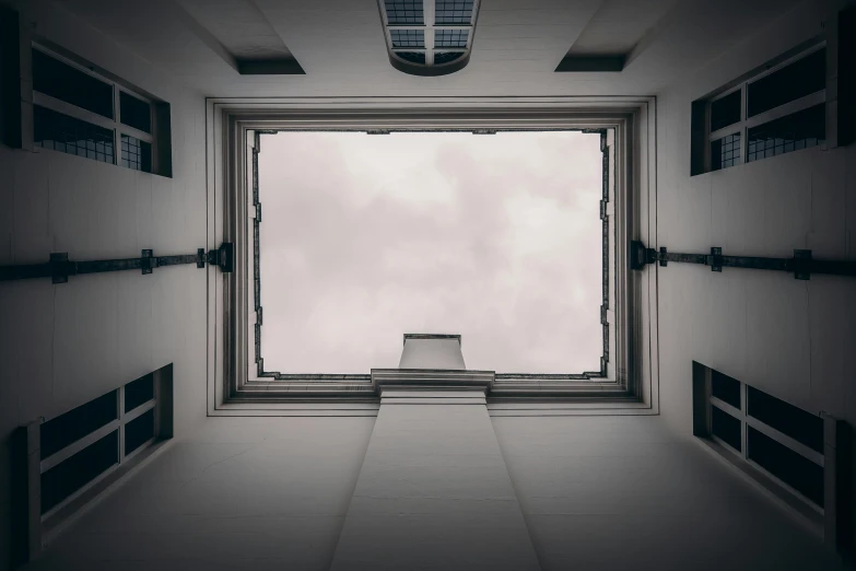 a big window looking out into a cloudy sky