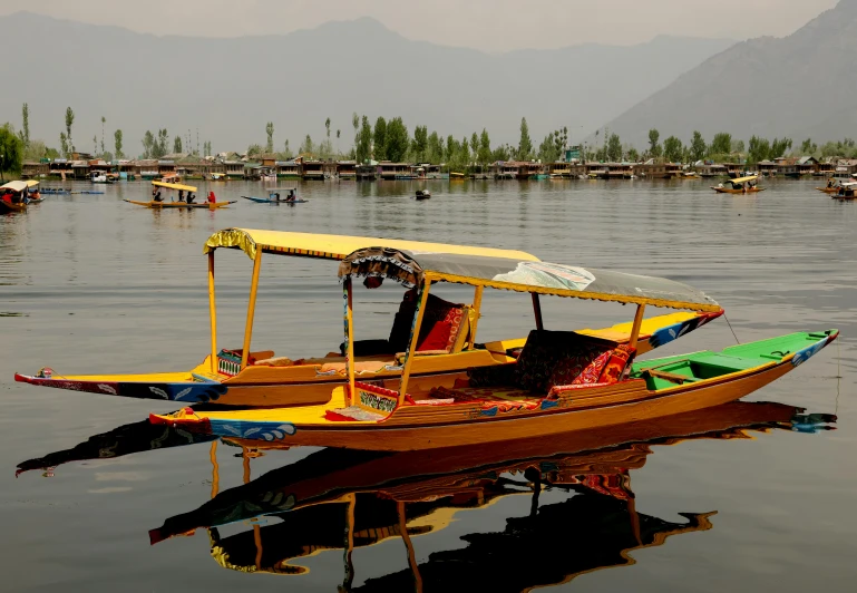 some boats floating in the middle of a lake