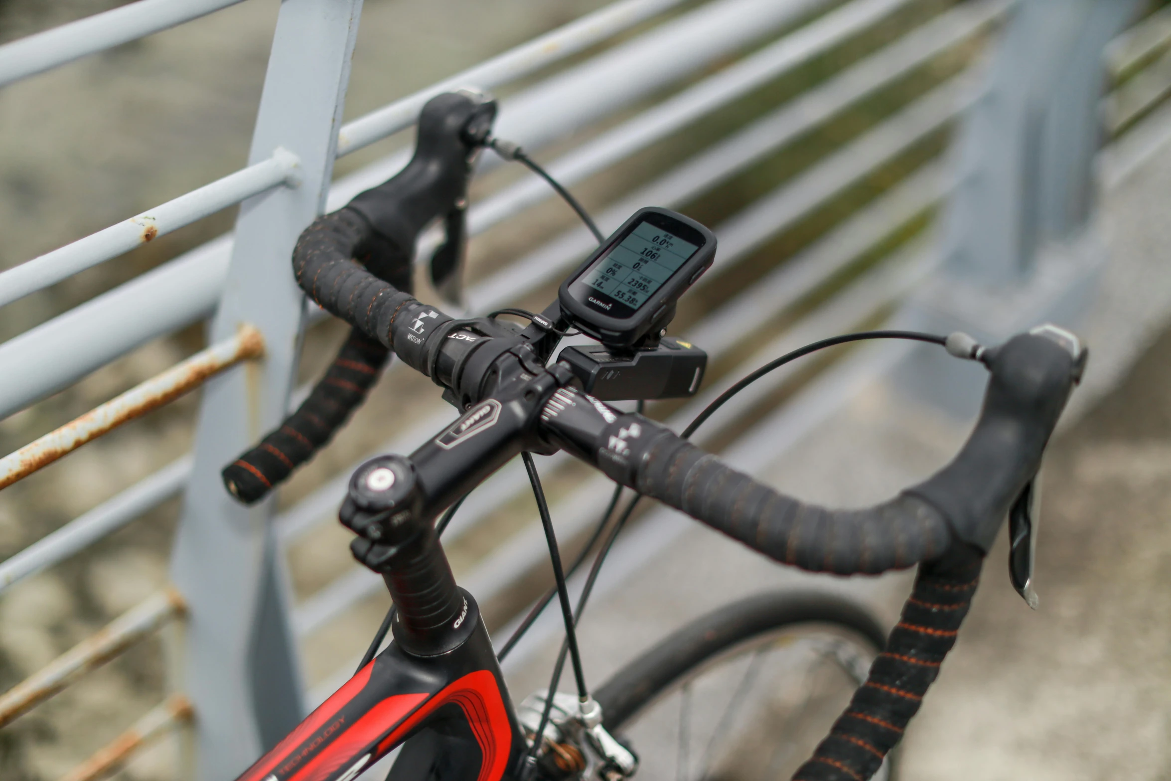 a bike locked to a metal guard rail