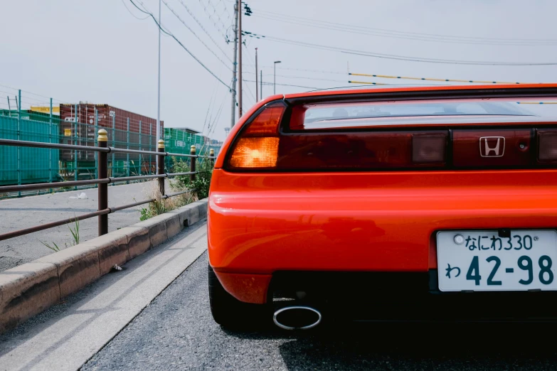 an orange car parked on the side of the street