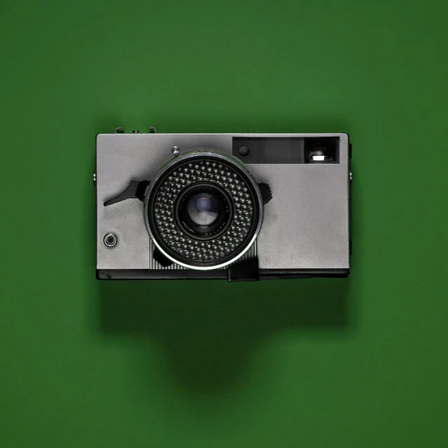 the back of an old fashioned camera on a green background