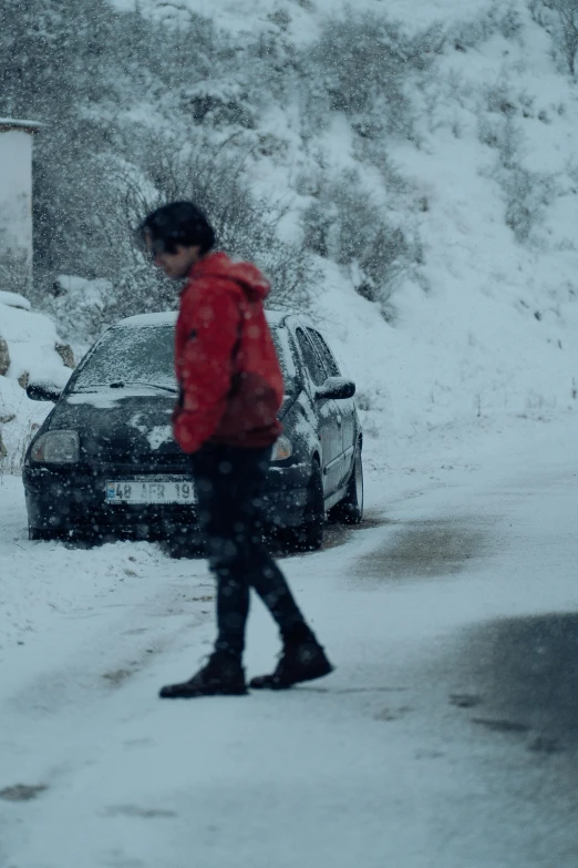 a person walking down a snow covered road