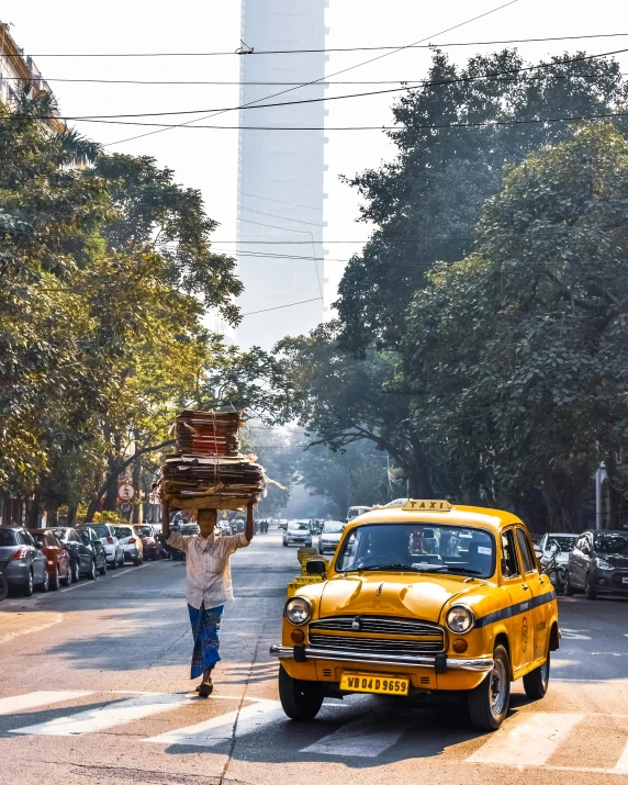 the person is crossing the street in front of a car