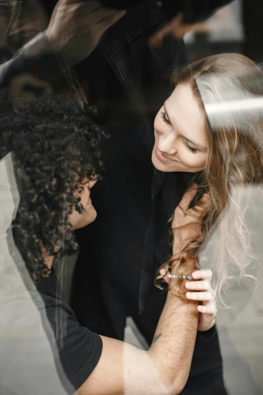 two people in a car looking out the window