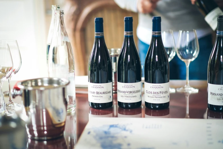 a bunch of bottles and some glasses sitting on a table