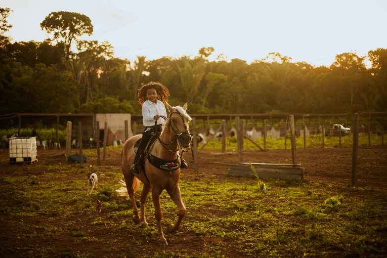 a  riding on the back of a brown horse