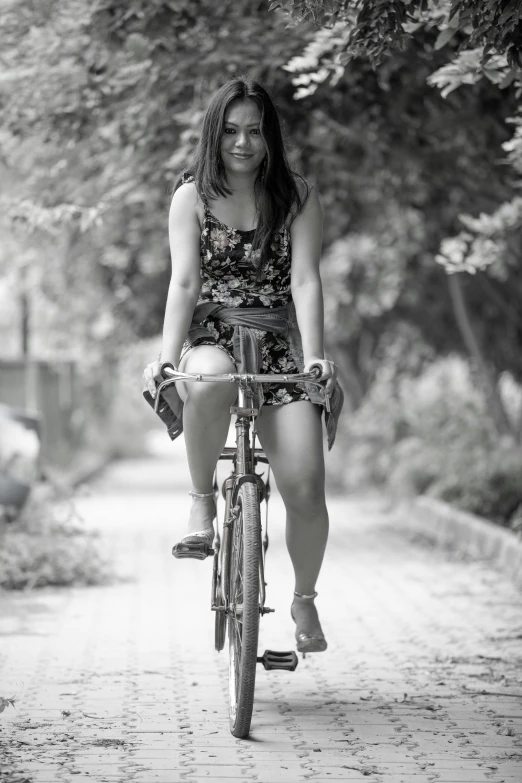 a woman in short shorts is riding a bicycle