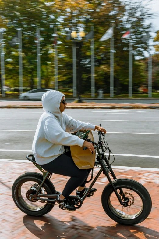 a man on a small motorcycle with a wooden bag on it