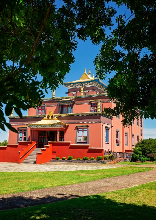 the large building is pink and yellow with a gold roof