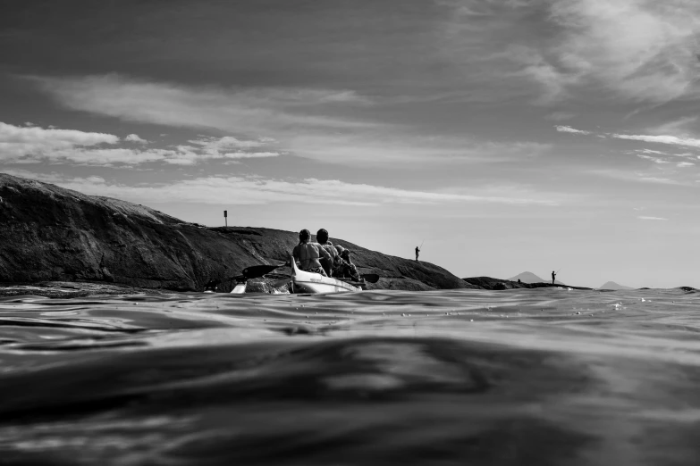 a man in a kayak sitting at the edge of the water