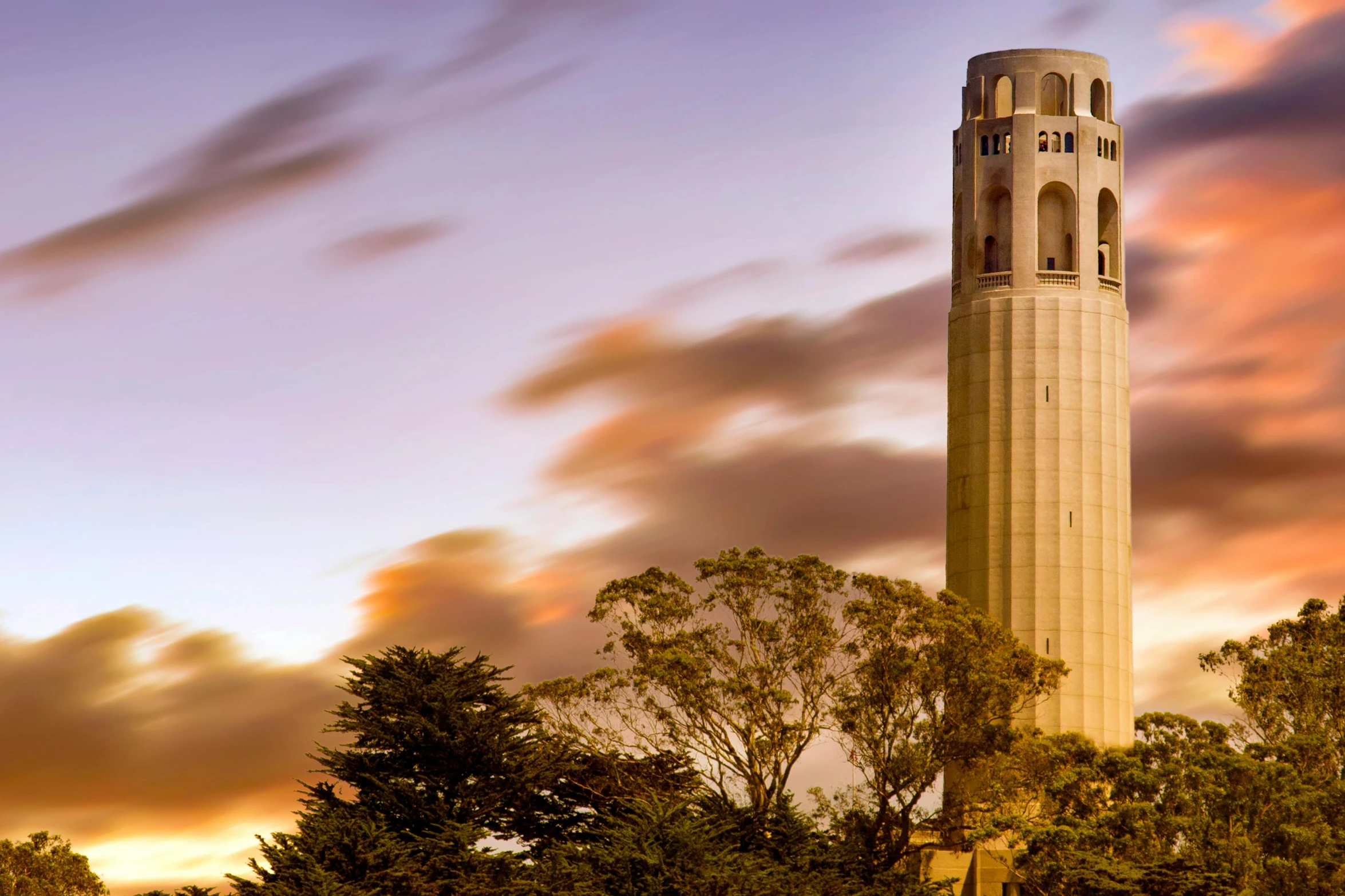 a tall clock tower with a cloudy sky background