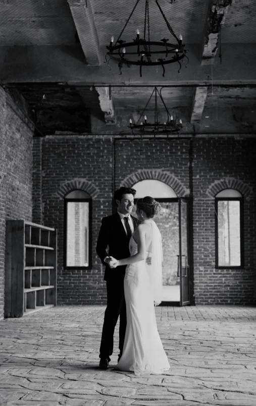 a man and woman in wedding attire standing together