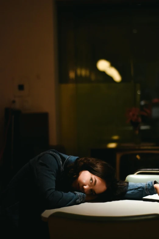 a girl is laying down on a couch while taking a nap