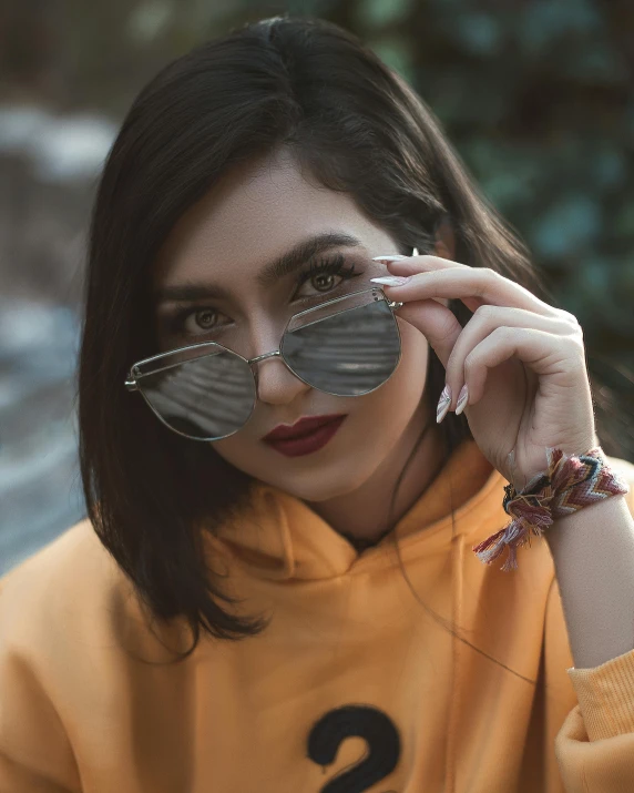 a woman is holding two pieces of pie near her face