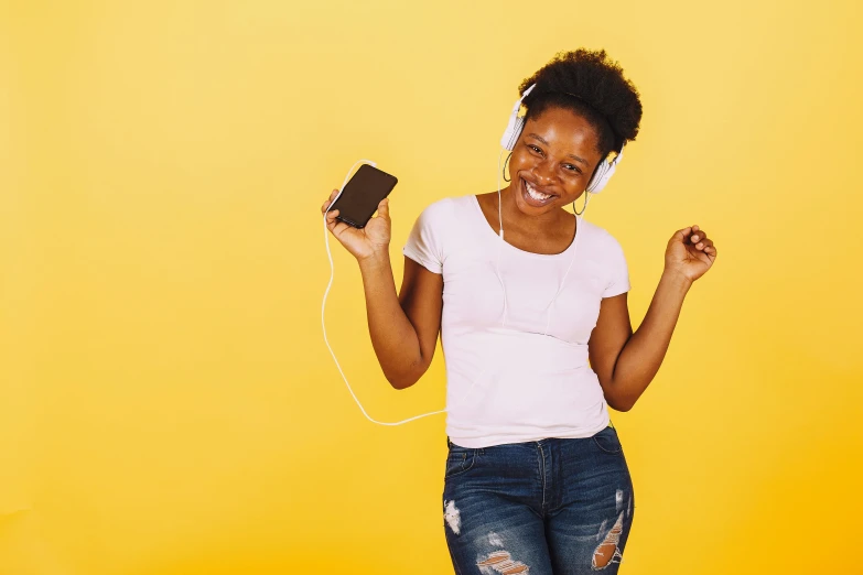 a woman in white shirt and jeans holding a phone