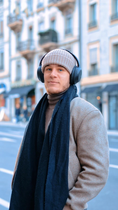 the man in the hat and scarf has a headset on