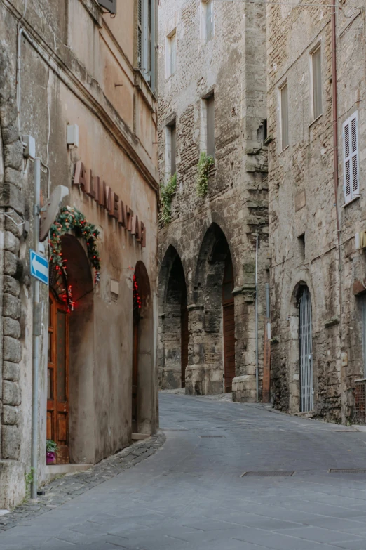 a narrow street with old stone buildings and windows