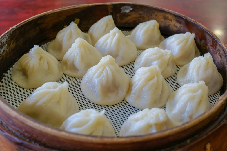 some dumplings on a brown plate with some chopsticks