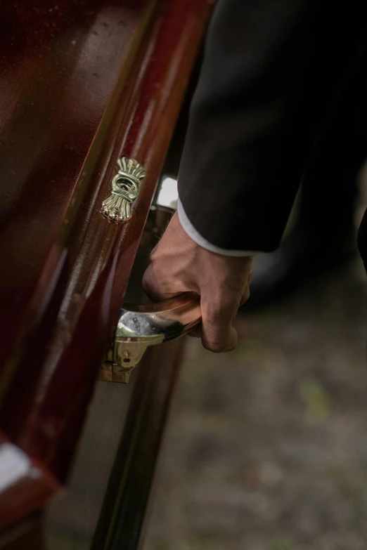 a close up of a person holding on to a chair