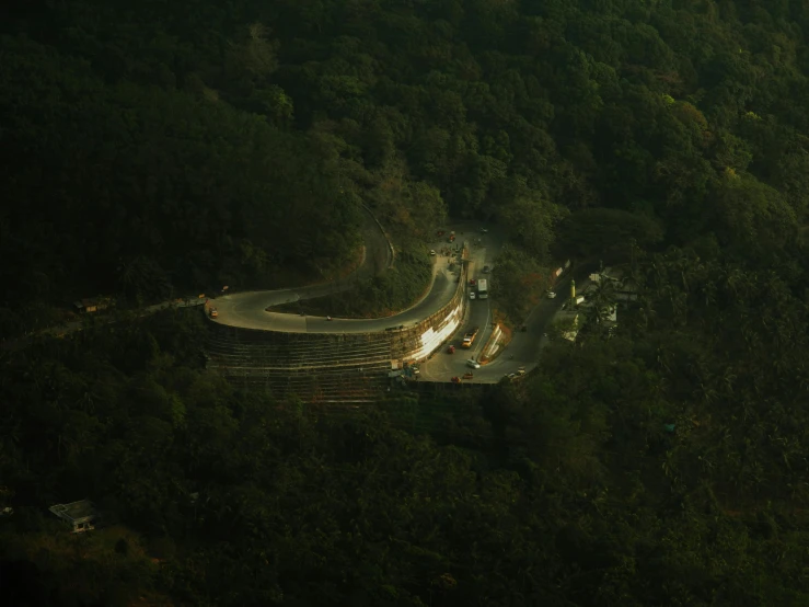 a road and trucks in the middle of a forest