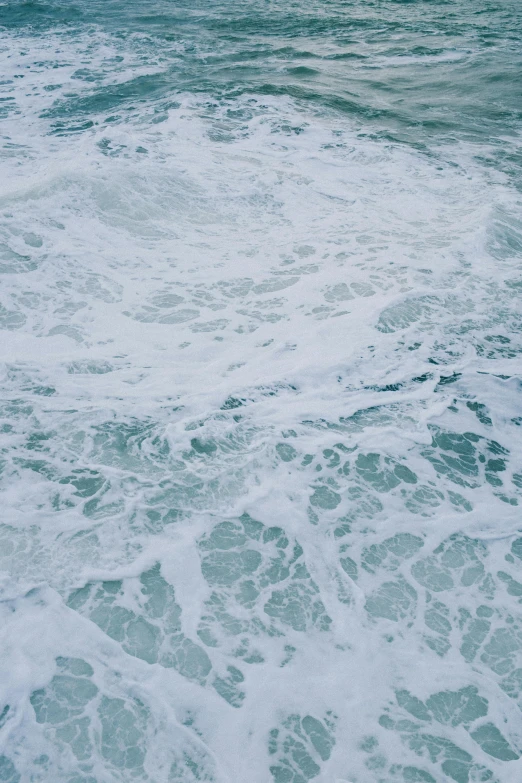 sea foam and waves on the water near the shore